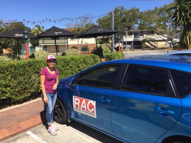 Learner beside a blue RAC-branded car