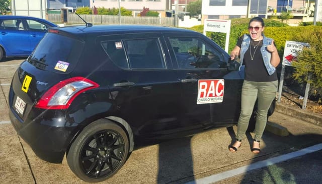 Learner beside a black RAC-branded car